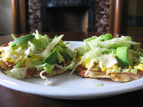 Sopes: thick tortilla with topping of meat, vegetables and sauces
