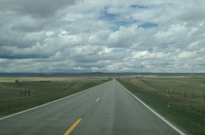 The open road in Montana, under a storm.