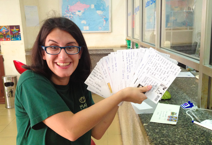 Z looking like a crazy scientist sending a ton of cards from Phnom Penh, Cambodia