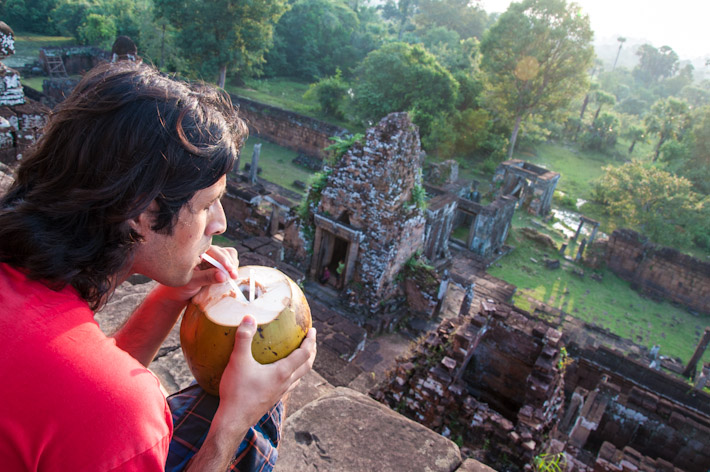 Ashray enjoying a young coconut as the sun goes down near Angkor Wat