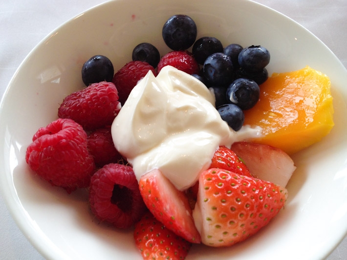 Raspberries, blueberries, strawberries and mango with lusciously thick yogurt