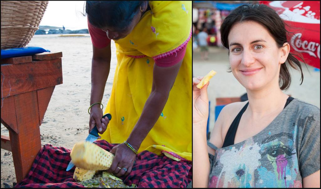 Enjoying freshly cut pineapple from a beach vendor in Vagator Beach, Goa