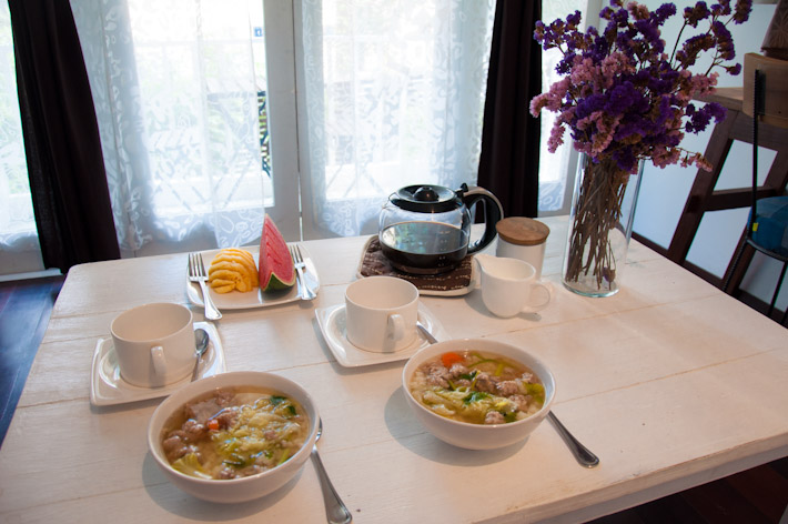 Thai Breakfast: rice congee with pork meatballs and veggies, seasonal fruits and coffee