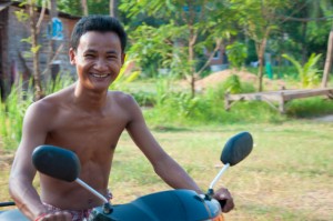 Smiling Man on bike in Cambodia