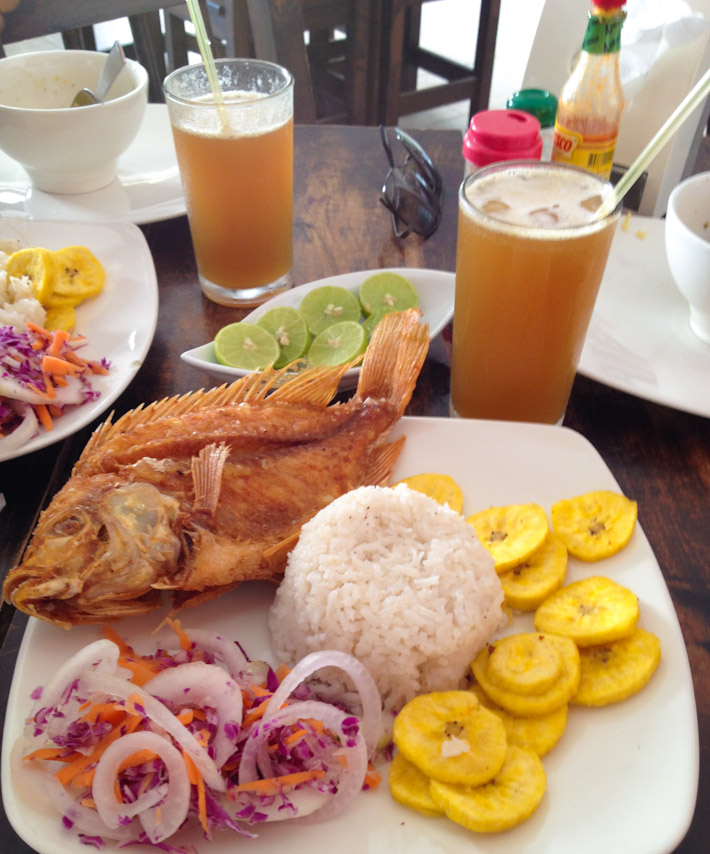 Fried Mojarra fish, coconut rice, fried plantains and "agua de panela" drink