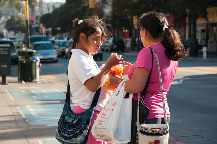 Mom and daughter share some sliced mangoes in The Mission