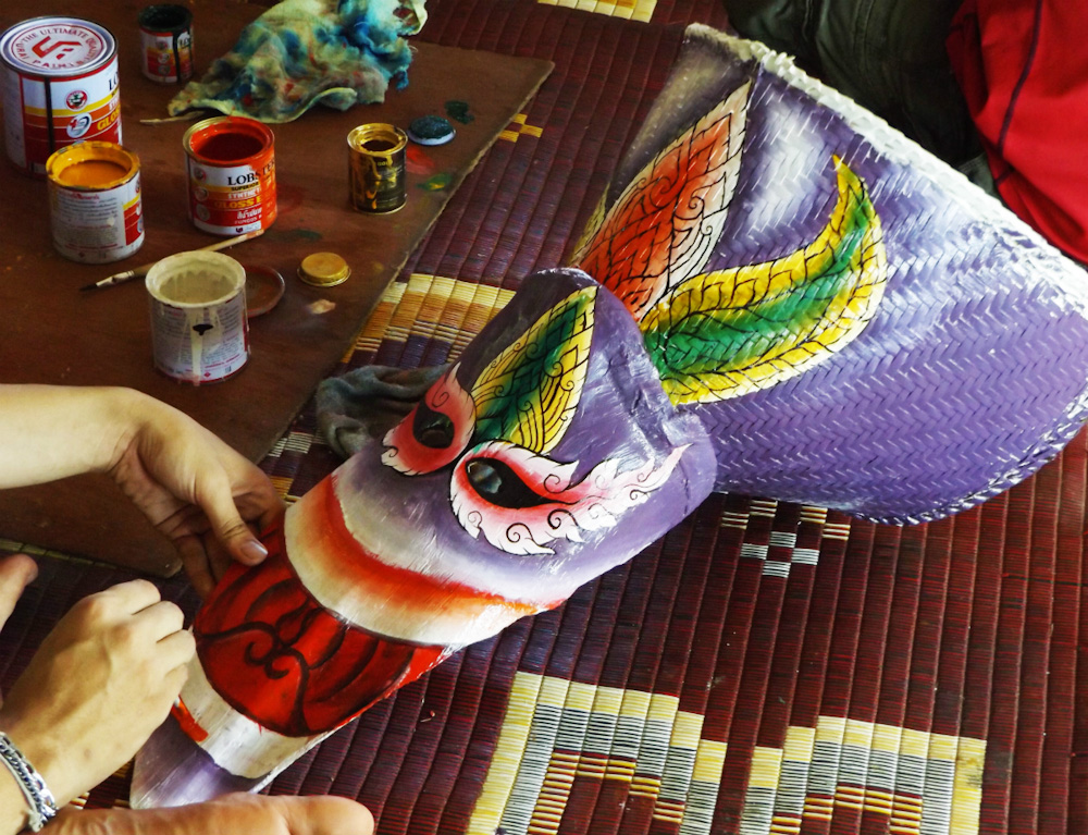 Painting a mask at Phi Ta Khon Festival Thailand - Loei