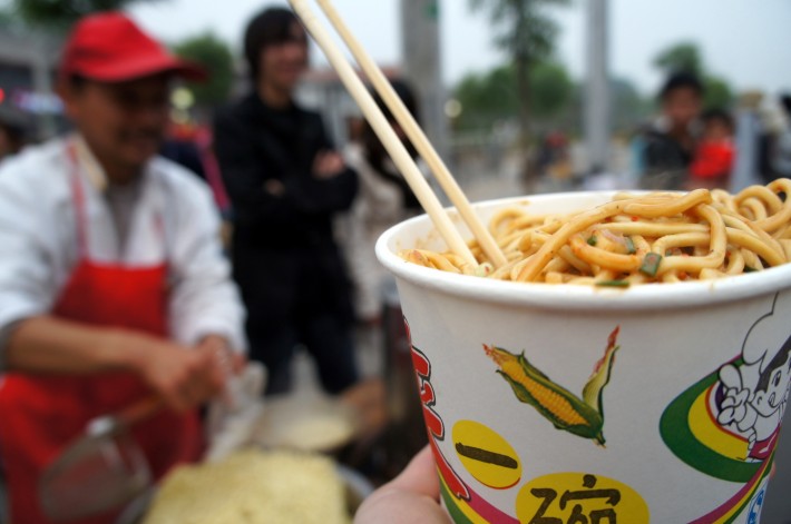 Getting a bowl of noodles from the street vendor in Beijing