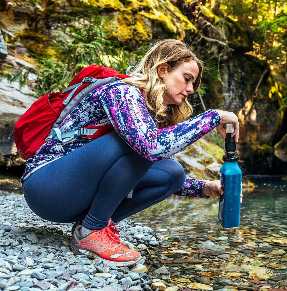 Enjoying drinking water straight out of nature, using a Sawyer water filter