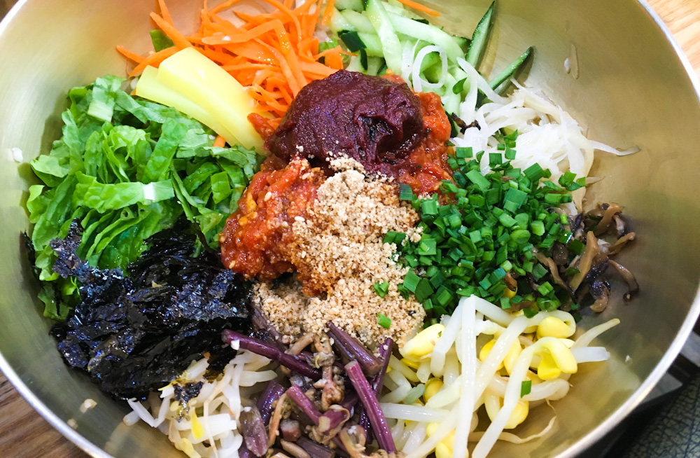 If this bowl of Bibimbap looks amazing on its own... wait until you see all the side dishes it's served with!...